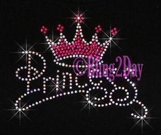 a pink and purple tiara on top of a black t - shirt that says king day