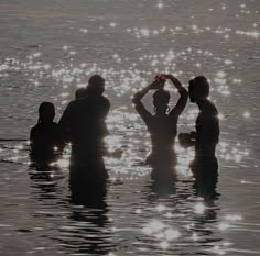 some people are standing in the water together