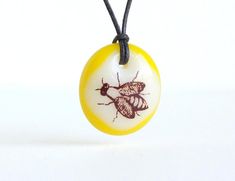 ⭐⭐⭐⭐⭐ Absolutely love my bee necklace! My toddler was completely mesmerized by it and it hangs at the perfect spot. It’s satisfying to touch it :) Definitely of wonderful quality! I’ve already had co-workers ask me where I got it. Happy to say it’s Made in Canada!  omeghaMOON  Honey Bee Necklace insect jewelry save the bees honey bee Cream / Yellow Honey Bee Jewelry, Fused Glass Pendant Necklace, Bee Lover Gifts, Bee Jewelry, Insect Jewelry, Fused Glass Pendant, Bee Necklace, Red Ombre, Bee Charms