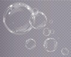 three transparent bubbles on a gray background