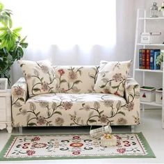 a living room scene with focus on the couch and rug in front of the window