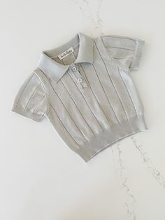 Bundle your baby up in cozy (and stylish!) comfort with this Knit Polo! The relaxed fit and knitted fabric of this super-soft shirt will keep your little one feeling relaxed and happy all day. With its front buttons and classic short-sleeve silhouette, they'll look absolutely darling! Knit Short Sleeve Tops For Loungewear, Short Sleeve Knit Tops For Loungewear, Gray Knit Short Sleeve Top, Casual Knit Tops For Playtime, Classic Cotton Soft Knit Tops, White Knit Playful Tops, Playful White Knit Top, White Playful Knit Top, Classic Soft Knit Cotton Tops