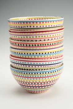 a stack of colorful bowls sitting on top of each other