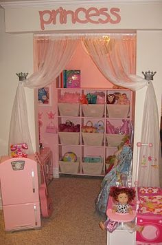 a pink princess bedroom with lots of toys