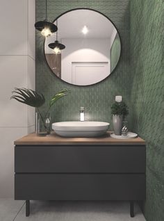 a bathroom with a round mirror above the sink