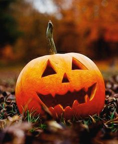 a carved jack o lantern sitting in the grass