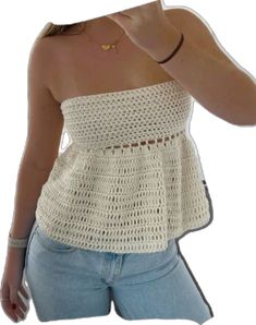 a woman wearing a white crochet top is taking a selfie