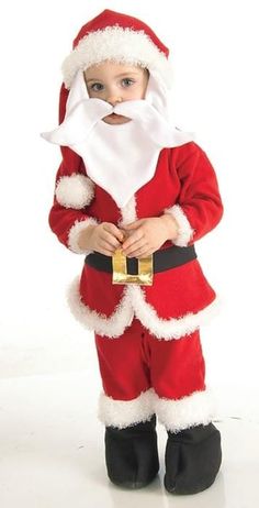 a little boy dressed up as santa claus