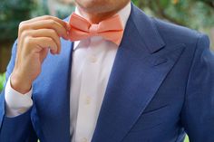 A dashing slub linen Bow Tie can make all the difference for your tailored wardrobe, and OTAA's Apricot Peach Pre-tied bowtie is a dapper choice. This piece is designed in Melbourne and made from a fine slub linen grain that is detailed with The Brothers at OTAA signature crest on the back.

There's simply nothing sweeter than the basics. OTAA’s Apricot Peach Bow Tie never disappoints with a soft linen material and subtle slubs speckling its solid surface. This lightweight beauty has just the ri Dapper Bow Tie For Spring Weddings, Dapper Spring Bow Tie For Weddings, Dapper Spring Wedding Bow Tie, Dapper Summer Bow Tie For Formal Occasions, Dapper Bow Tie For Summer Formal Occasions, Dapper Bow Tie For Summer Formal Events, Dapper Formal Bow Tie For Summer, Dapper Summer Formal Bow Tie, Dapper Bow Tie For Business In Summer