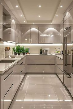 a modern kitchen with stainless steel appliances and white counter tops, along with marble flooring