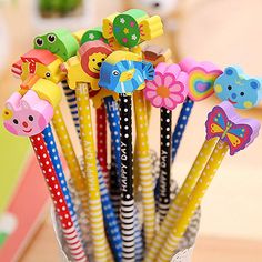 several colorful pencils are in a cup on the table