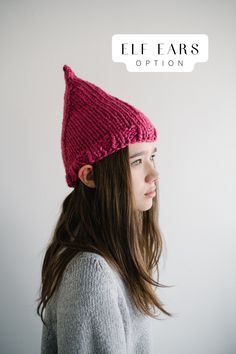 a woman wearing a pink knitted hat with the words elf ears option above her head