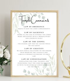 a temple ceremony sign with white flowers and greenery on the table next to it