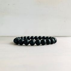 "This is a unisex beaded bracelet made with 8mm Onyx beads. It is a stretch bracelet made with premium elastic cording. Comfortable to wear and easy to remove. Suitable for Men Women Teens and makes nice gifts.  Onyx is a powerful protection stone it transforms and absorbs negative energies while preventing strain on your personal energies. Black Onyx is very helpful in times of emotional and stress, grief, or confusion.    Like to see more bracelets head to Birdtreejewelry.Etsy.com  Thanks for Mens Bracelet Black, Nice Gifts, Black Onyx Bracelet, Wood Bracelet, Bracelet Mens, Onyx Bracelet, Mala Bracelet, Protection Stones, Stackable Bracelets