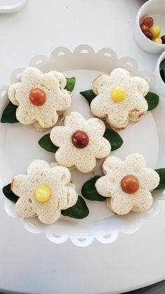 small cookies decorated with flowers on a white plate