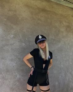 a woman dressed as a police officer posing for the camera with her hands on her hips