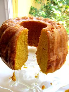 a bundt cake on a plate with one slice cut out