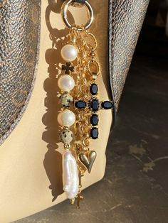 a close up of a purse on a mannequin's torso with beads and charms