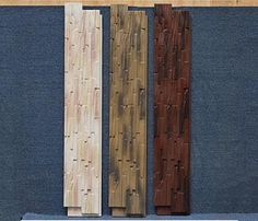 three pieces of wood sitting next to each other on a blue carpeted flooring