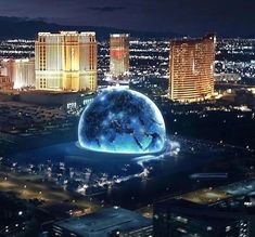 an aerial view of the las vegas strip at night with buildings lit up in the background