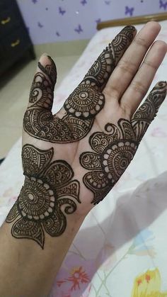 a person's hand with henna tattoos on it