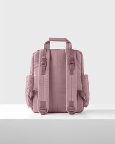 a pink backpack sitting on top of a white table