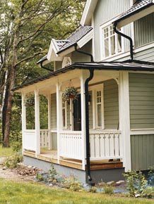 a house with white trim and green siding