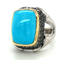 This stunning statement ring features an exquisite, 11.09 carat gem from the renowned Sleeping Beauty turquoise mine! Arizona's Sleeping Beauty mine is home to the finest "robin's egg blue" turquoise, but the mine was closed in 2012. With no plans to reopen, the fine-quality turquoise from this mine is becoming increasingly rare. We set this gem in a beautifully hand-engraved, 18k white gold ring with a custom-made 18k yellow gold bezel. Luxury Turquoise Ring With Gemstone Accents For Anniversary, Luxury Turquoise Gemstone Ring, Formal Fine Jewelry Turquoise Ring With Accent Stones, Formal Turquoise Rings With Gemstone Accents, Luxury Turquoise Ring As A Gift, Elegant Turquoise Ring With Polished Finish, Luxury Blue Turquoise Ring For Formal Occasions, Luxury Oval Turquoise Ring, Formal Turquoise Ring With Accent Stones