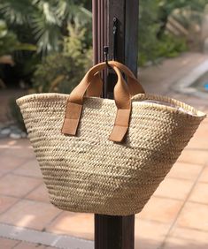 The Atlantica is one of our most popular straw bags. This woven raffia tote bag is designed with leather top handles.  Available with the following leather handles - - tan leather - black leather Product info: - natural raffia - leather handles - fully lined  - drawstring closure - internal zip pocket Inspired by the Mediterranean island lifestyle, this straw beach tote is perfect for your vacation getaways and city escapes. Calling all summer lovers! Dimensions: 64cm (L) x 34cm (H) x 10cm (D) - Brown Leather Straw Bag With Rolled Handles, Leather Straw Bag With Rolled Handles For Vacation, Leather Straw Bag With Rolled Handles For Travel, Leather Straw Bag With Rolled Handles For Daily Use, Daily Use Leather Straw Bag With Rolled Handles, Beige Leather Straw Bag With Woven Detail, Shopping Straw Bag With Woven Leather Double Handle, Chic Brown Straw Bag With Rolled Handles, Natural Leather Basket-shaped Bucket Bag