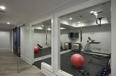 a gym with exercise balls and equipment in the room, as seen through large glass windows