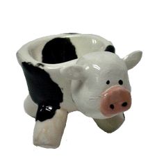 a ceramic cow shaped cup is shown on a white background