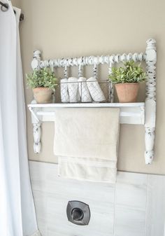 a white towel rack with plants on it