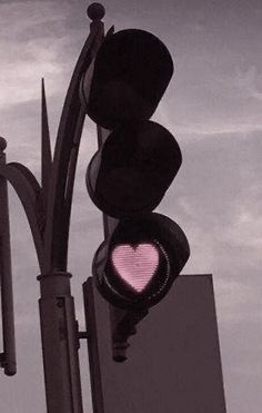 a traffic light with a pink heart on it