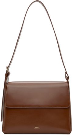 Buffed leather shoulder bag in brown. · Adjustable pin-buckle shoulder strap · Logo embossed at face · Patch pocket at back face · Magnetic foldover flap · Patch pocket at interior · Partial suede lining · Partial cotton twill lining · Gold-tone hardware · H7.5 x W9.75 x D3 Supplier color: Hazelnut Classic Brown Flap Shoulder Bag, Brown Saddle Bag For Office, Brown Flap Shoulder Bag For Office, Classic Brown Shoulder Bag With Removable Pouch, Brown Flap Bag For Office, Formal Brown Saddle Bag With Adjustable Strap, Formal Brown Shoulder Saddle Bag, Brown Office Saddle Bag With Magnetic Closure, Office Brown Saddle Bag With Magnetic Closure