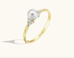 Formal White 14k Gold Pearl Ring, Timeless White Pearl Ring In 14k Gold, 14k Gold Pearl Ring With Single Diamond For Promise, Classic Pearl Promise Ring With Center Stone, Formal Yellow Gold Pearl Rings, Classic Pearl Ring With Single Diamond For Anniversary, 14k Gold Pearl Ring With Prong Setting For Promise, Classic Yellow Gold Pearl Ring With Single Diamond, Classic Yellow Gold Pearl Ring With Diamond