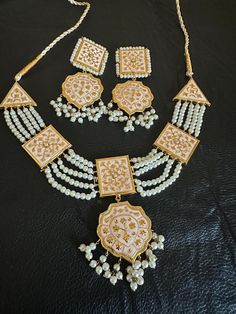 These beautiful and lightweight hand painted meena kari earrings and necklace set made to take you in a journey of elegance and grace! This one is made for charmer like you with all the love from Noorzaracollection. Color : white made to order in 3-4 weeks.... Note :Color, shades, texture displayed may slightly vary from the actual product due to digital image limitations. We request you to consider these minor variations. Please expect the possibility of some slight imperfections when buying handmade jewelry. If you have any questions, please contact us. Care instructions : Jewelry caring is a very important part once you use them on a regular basis. We advise you to do the following things to keep them lasts longer: Keep your jewelry away from water, chemicals HairSpray,Perfume. Avoid we Luxury Handmade Temple Jewelry Danglers, Traditional Meenakari Teardrop Jewelry, Festive Meenakari Teardrop Jewelry, Festive Brass Meenakari Earrings, Elegant Meenakari Brass Earrings, Festive Gold-plated Meenakari Chandelier Earrings, Pakistani Earrings, Light Weight Jewelry, Kundan Earrings