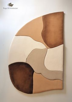 a piece of art that looks like an abstract painting with brown, beige and white colors