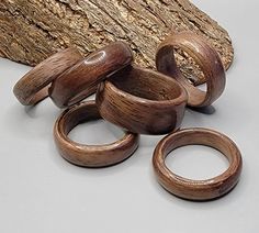 several wooden rings sitting on top of a piece of wood