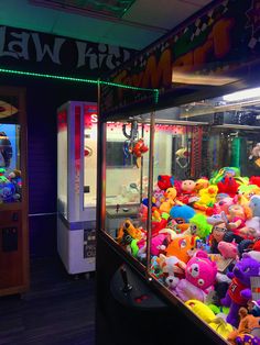 there are many stuffed animals in the vending machine at this carnival park ride attraction