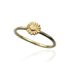 Daisy Ring Birth Flower Collection A stunning daisy ring that will appeal to everyone - even if you don’t happen to be born in April, the month that gets to call this adorable bloom it’s birth month flower. The daisy flower can sometimes get a bad rap, but we love their tiny petals and simple beauty. The subtle, fresh design of this daisy ring is a lovely way to celebrate your birth flower or love for these dainty flowers, which symbolise love and fertility. Like a bit of glitzy shimmer? Why not Delicate Birth Flower Ring, 14k Gold Birth Flower Rings, Dainty Flower Ring With Flower Charm, Adjustable 14k Gold Flower Ring, Anniversary Flower Ring With Sunflower Design, Anniversary Sunflower Design Flower Ring, Yellow Gold Birth Flower Rings, Yellow Gold Flower Ring With Birth Flower Detail, April Birth Flower