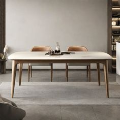 a dining room table and chairs in front of a book shelf