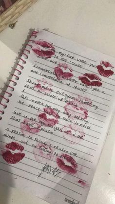 a notebook with red lipstick imprints on it