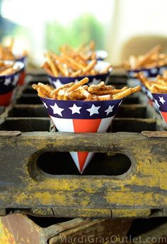 some food is sitting in small red, white and blue bowls