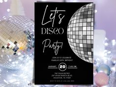 a disco party flyer is displayed on a table with silver and black decorations, such as balls