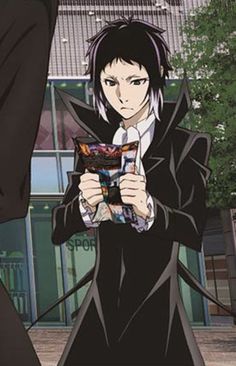 an anime character with black hair holding a book in front of him and looking at the camera