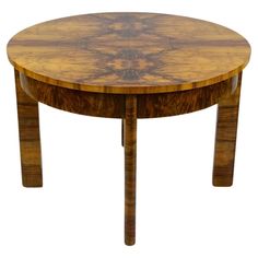 a round wooden table with two legs and a circular wood table top on one end