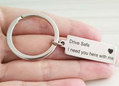 someone is holding a keychain that says drive safe i need you here with me