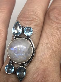 Large Vintage ring set with huge Rainbow Moonstone with Aquamarine Low content silver not sterling About an in long Size 6 can be resized at my jeweler for a $10-$20 fee All rings are shipped free in the US in a nice gift box. Check out our over a THOUSAND great reviews Engraving is $4 per letter and is not always perfect depending on the piece. It can take a few days if the jeweler is busy. This is payable to Paypal Judithsltd@gmail.com Spiritual Round Blue Topaz Jewelry, Multi-stone Round Moonstone Jewelry, Multi-stone Moonstone Round Jewelry, Silver Multi-stone Celestial Jewelry, Blue Topaz Natural Stone Ring, Round Multi-stone Moonstone Jewelry, Moonstone Multi-stone Round Jewelry, Silver Celestial Multi-stone Jewelry, Moonstone Ring With Large Round Stone