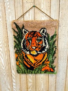 a tiger rug hanging on the side of a wooden wall