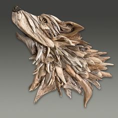 an animal made out of driftwood on a gray background with the head of a wolf